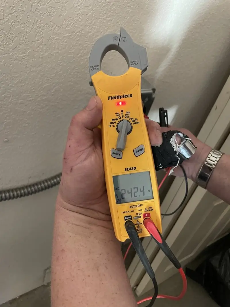 Voltage testing with clamp meter during Electrical Installation Services in Thruston